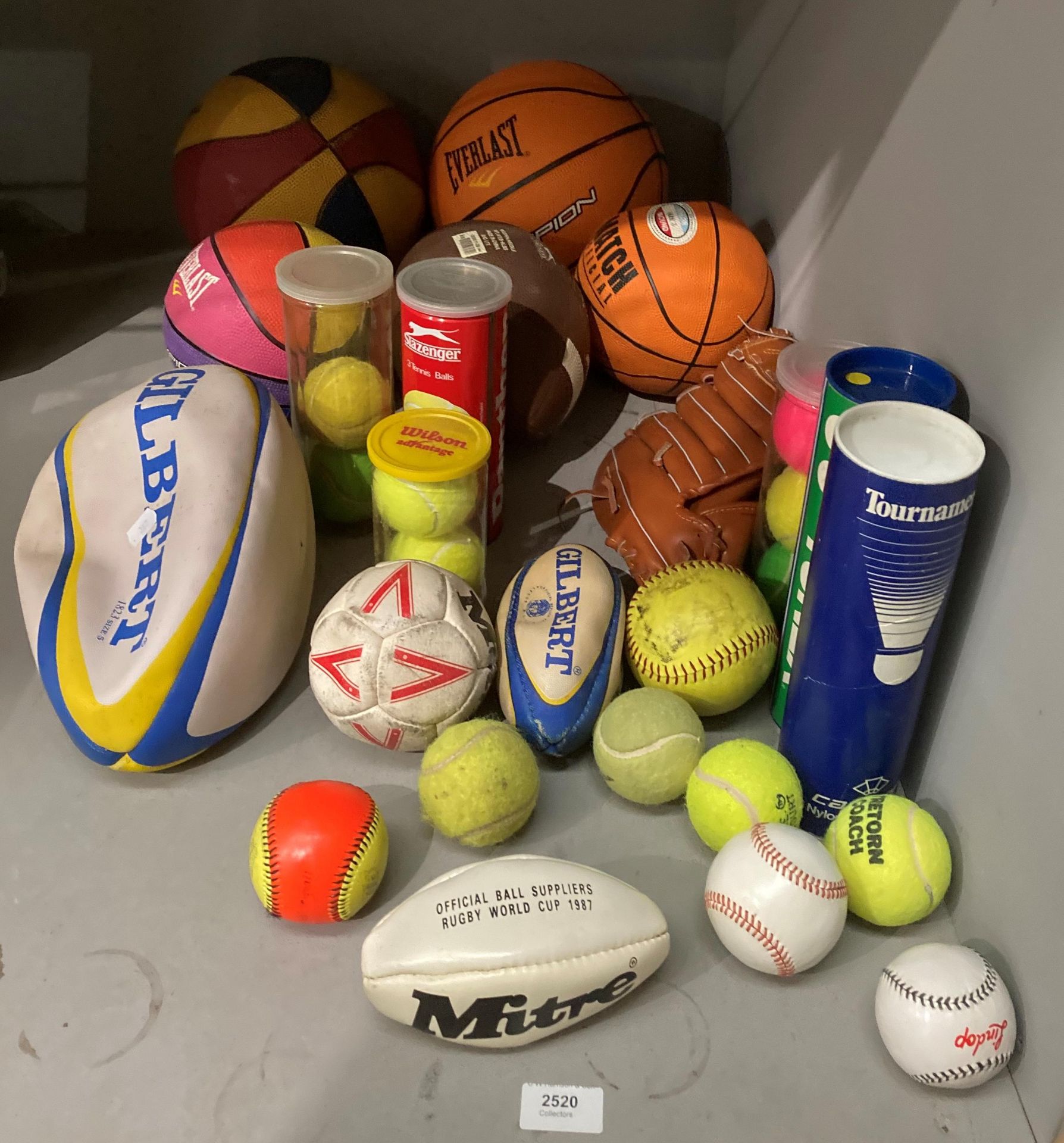 Contents to corner of rack a quantity of sports balls - basketball, rugby, baseball glove and ball,