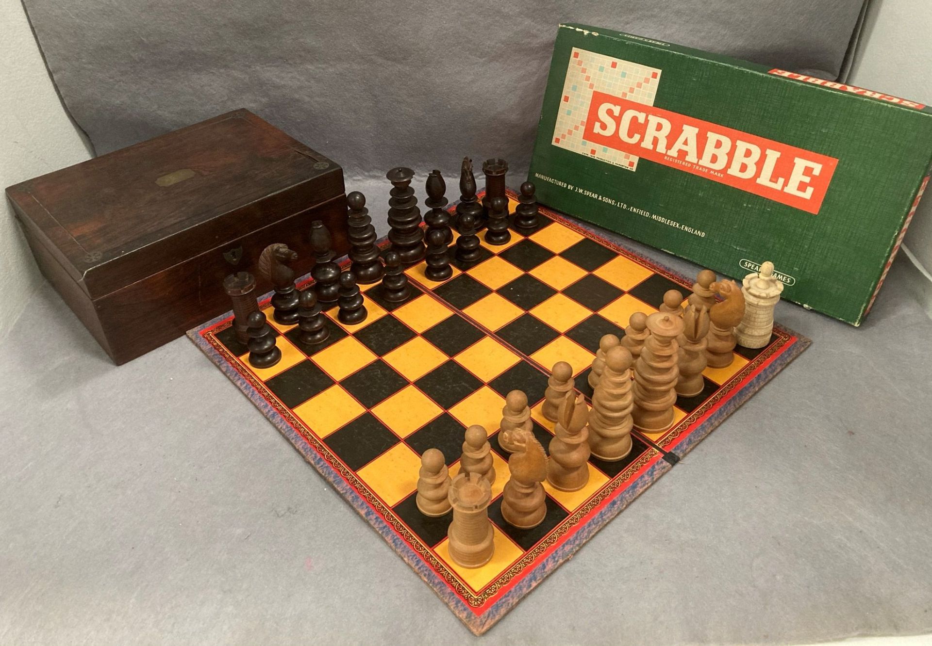 A wood chess set with one replacement castle and several pieces damaged complete with a walnut box