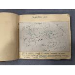 An autograph book, badly distressed,