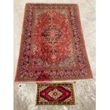 A red and brown patterned Eastern rug 210cm x 142cm and another small rug 66cm x 35cm