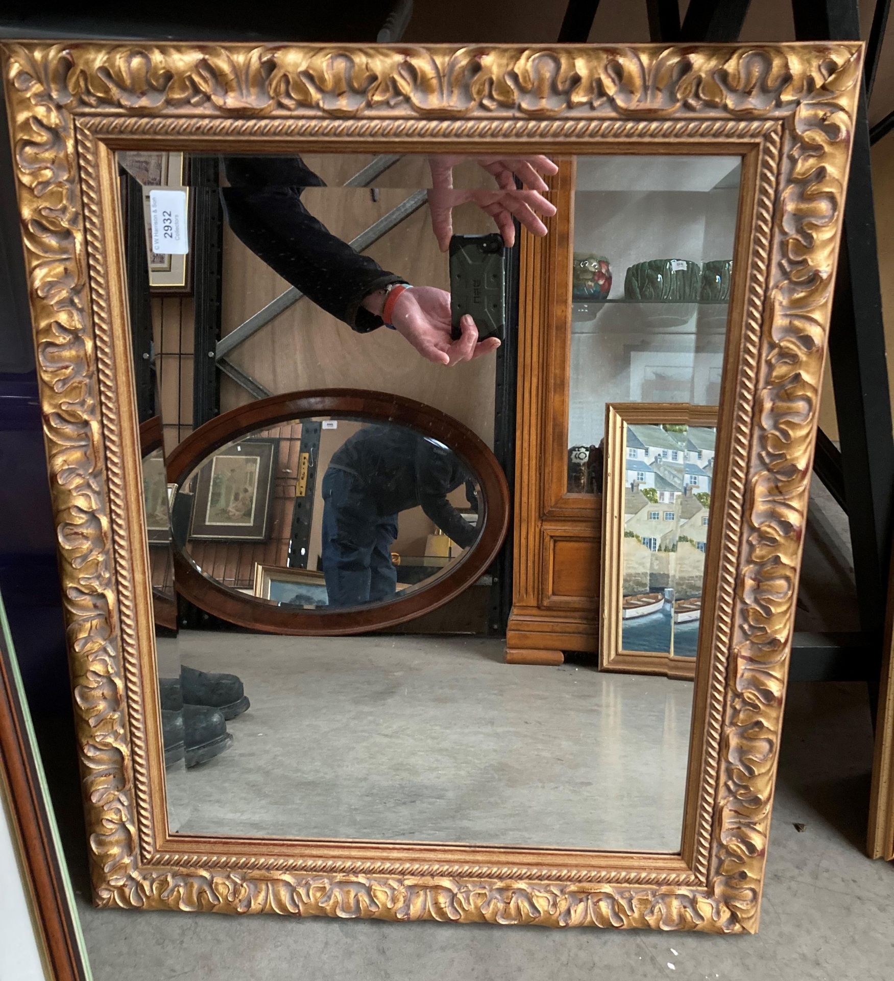 An ornate gilt framed mirror 64cm x 54cm