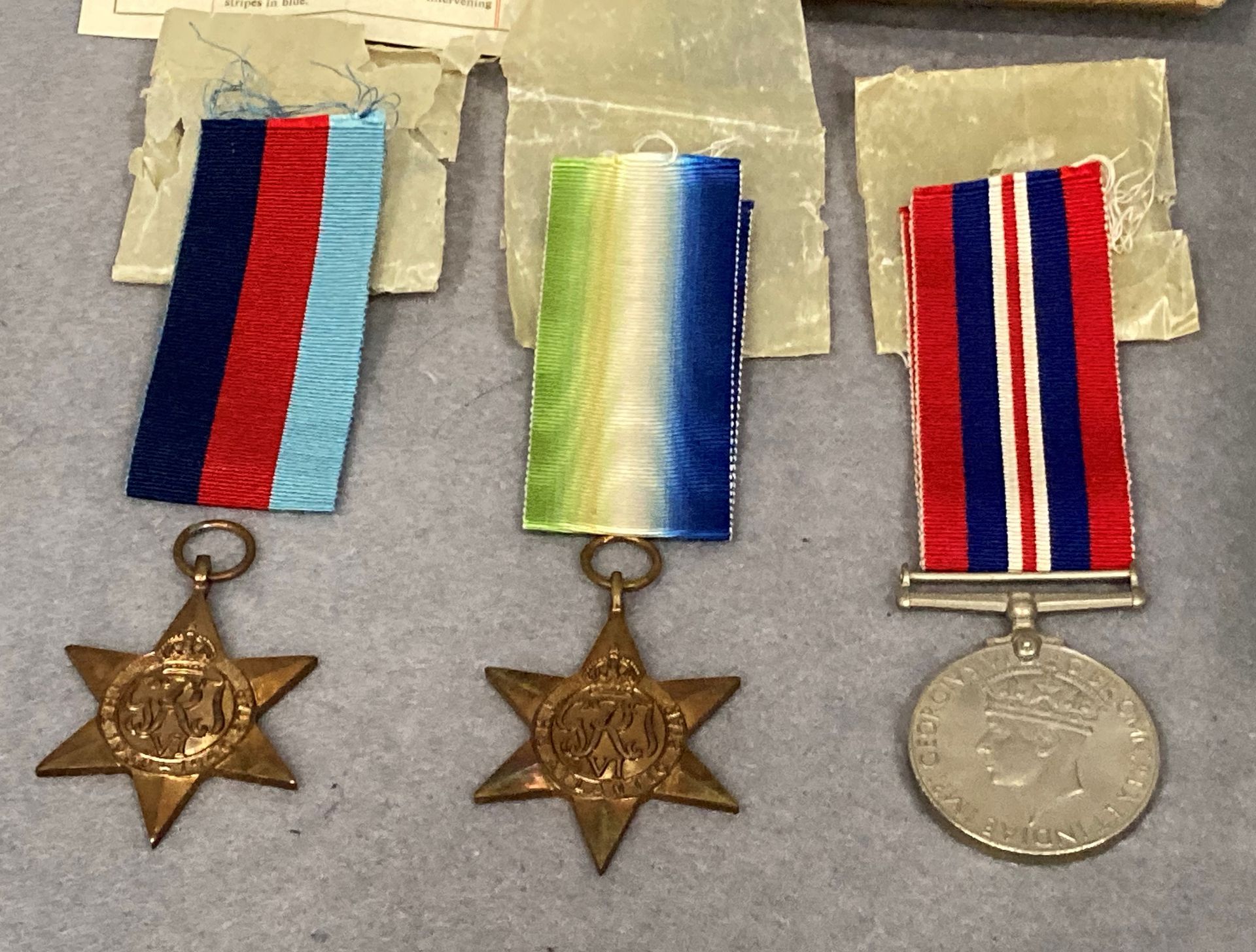 Three Second World War medals and ribbons in a box addressed to Mr. S. - Image 2 of 2