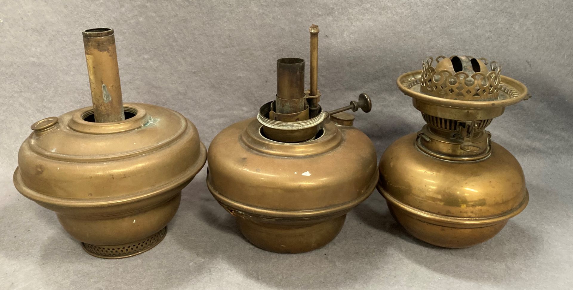 Three assorted brass oil base bases/fittings