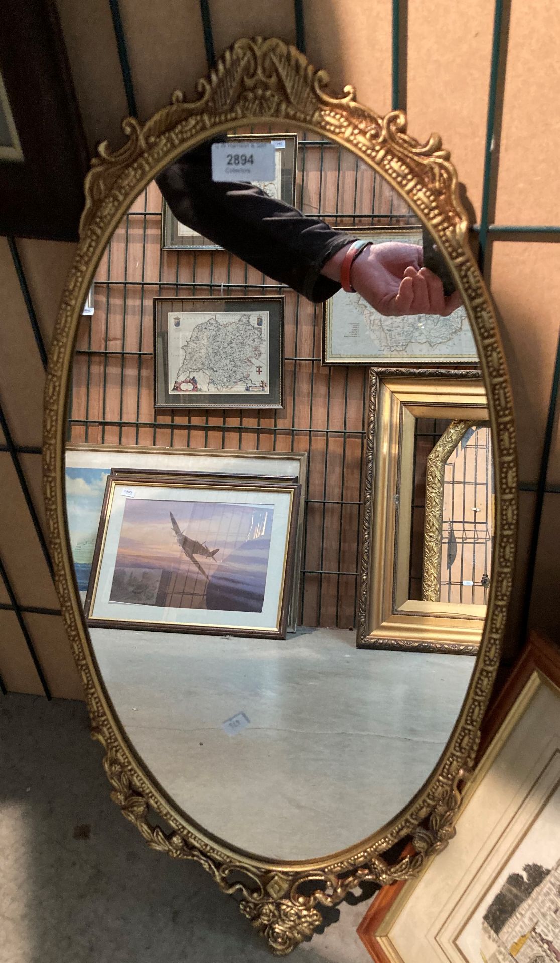 Ornate gilt framed oval wall mirror 70cm x 33cm