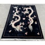 A Chinese 100% wool rug with two ivory dragons on a black background 184cm x 120cm