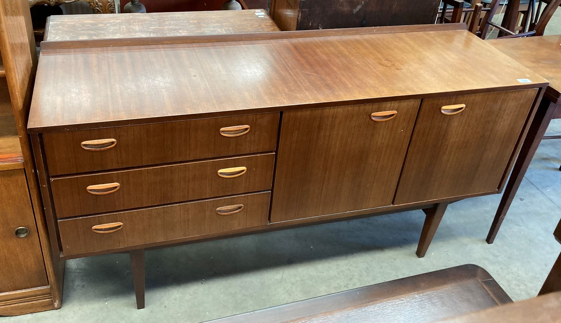 A Beautility teak finish three drawer,