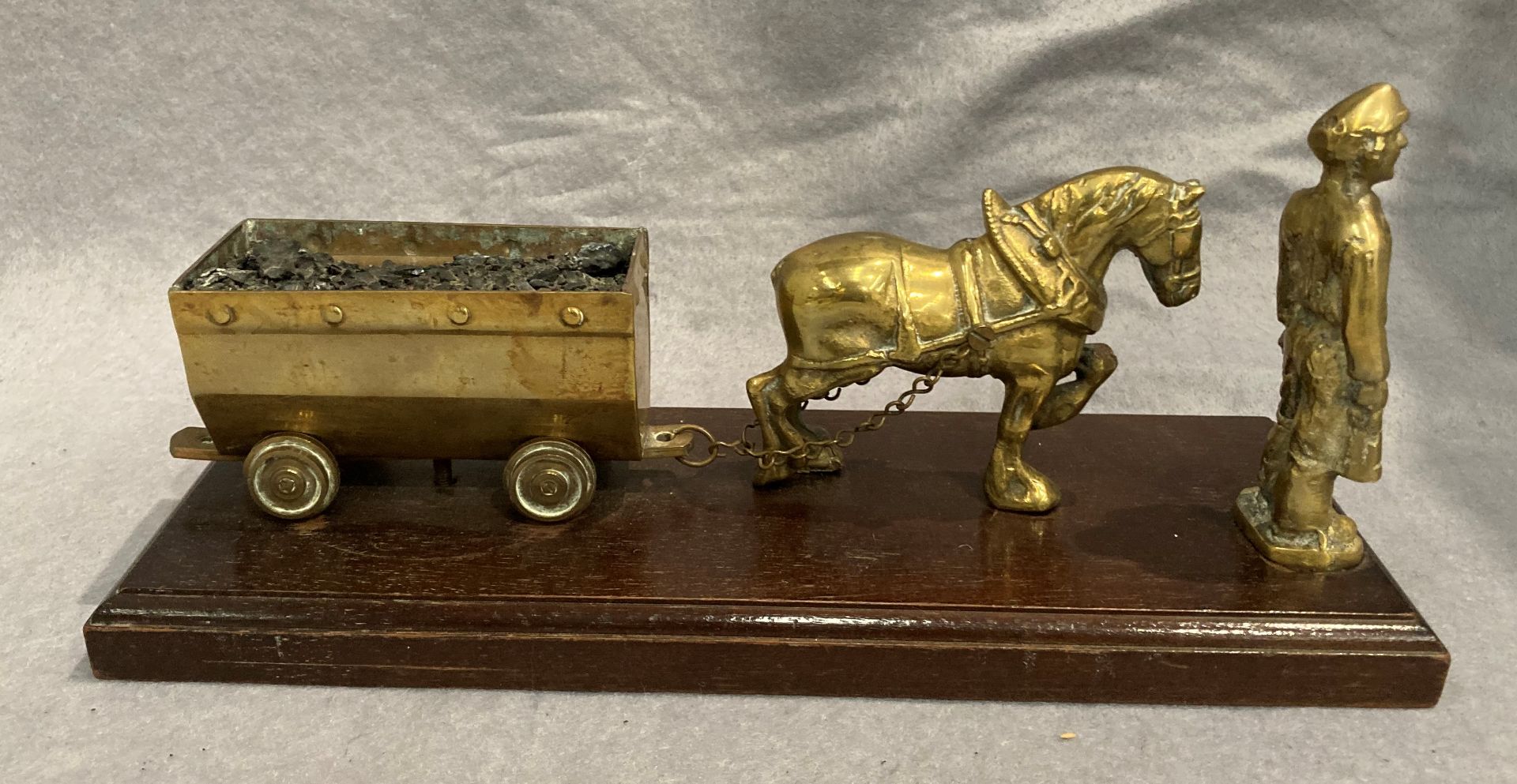 A brass mining model featuring a pit pony pulling a coal wagon and a miner 31cm long