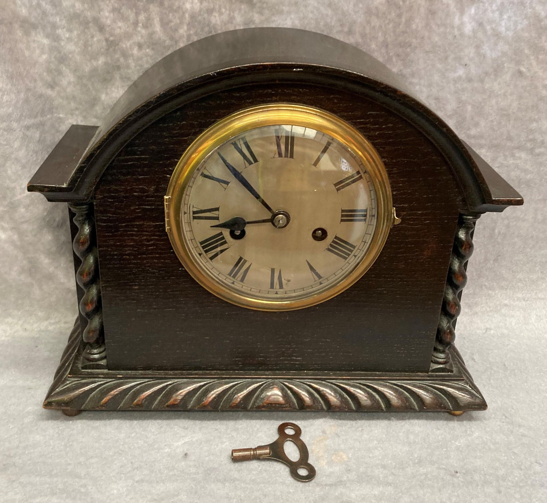 An oak cased mantel clock 34cm x 26cm high complete with key