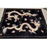 A Chinese 100% wool rug with two ivory dragons on a black background 370cm x 275cm