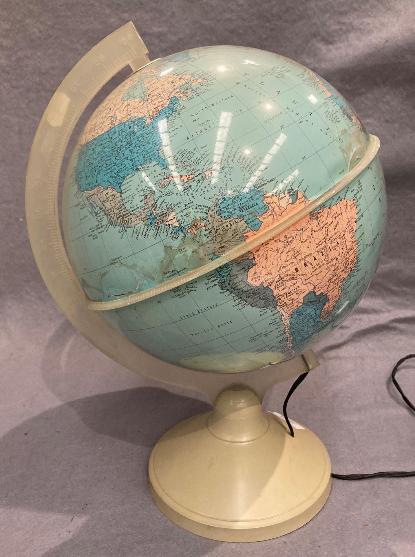 An illuminating globe on plastic stand 40cm high