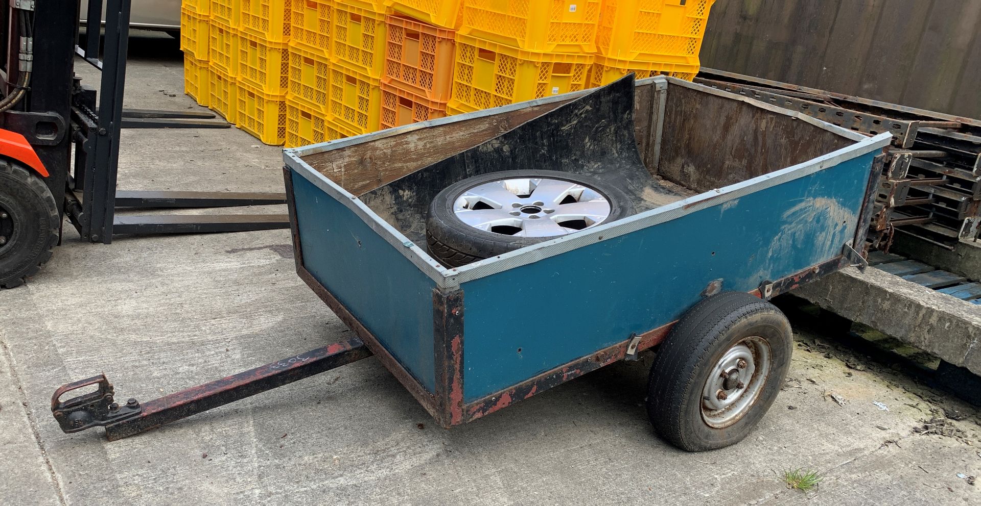 A small single axle box trailer, metal framed with wood sides and base (base needs repairing),