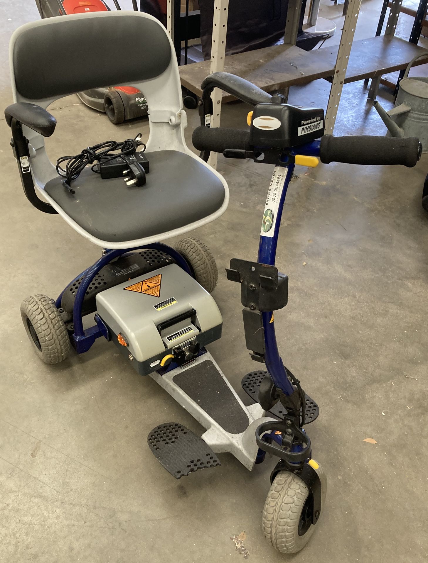 A three wheel mobility scooter in blue complete with battery,