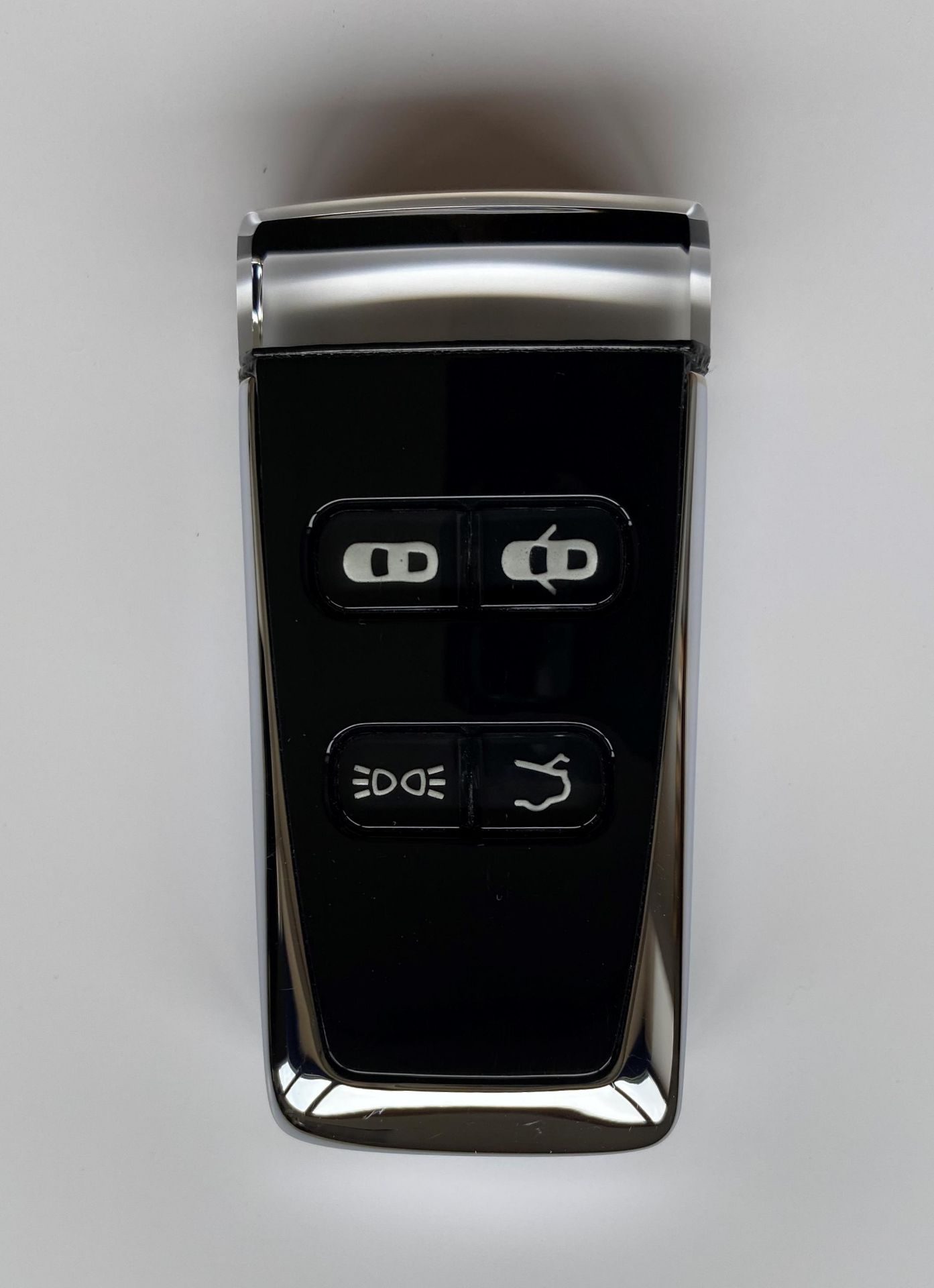 AN ASTON MARTIN EMOTION CONTROL GLASS KEY FOB.