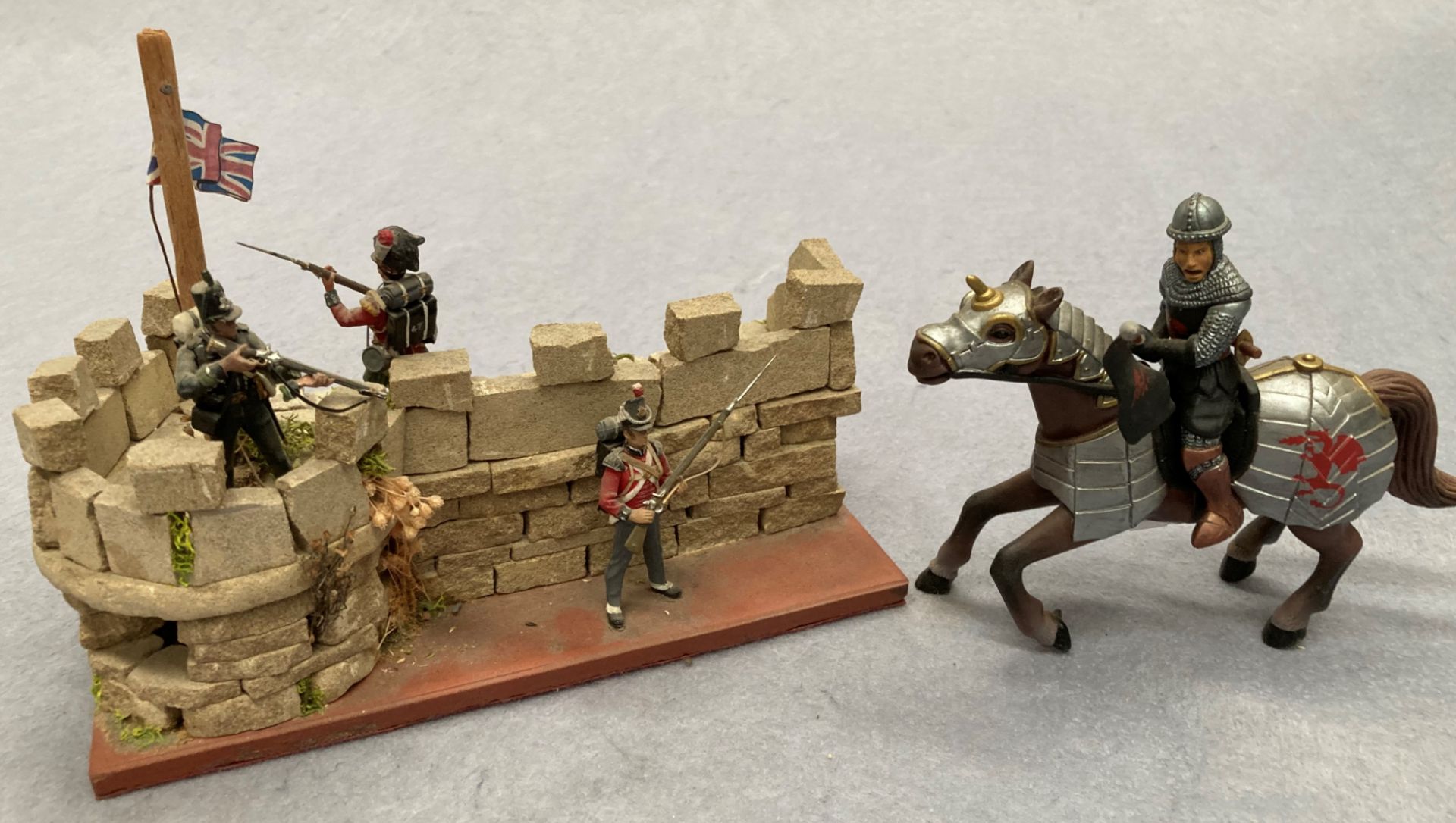 A scale model of a Medieval Knight/horseman in full armour and a scale model of a Napoleonic war