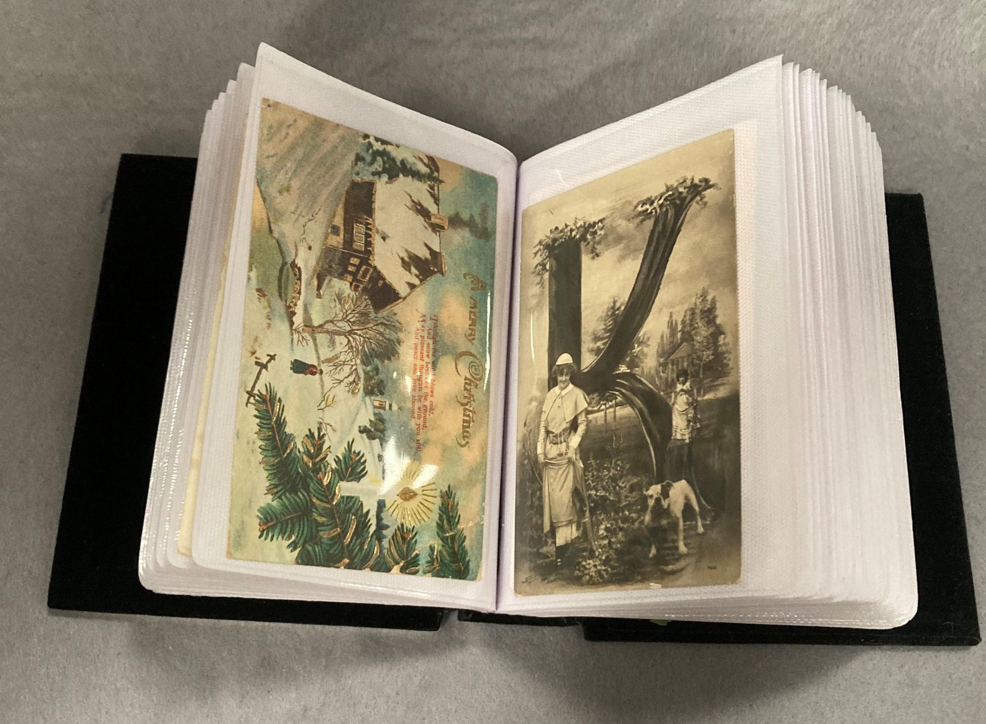 A small photo album containing 100 assorted mainly early 20th Century greetings and sentimental