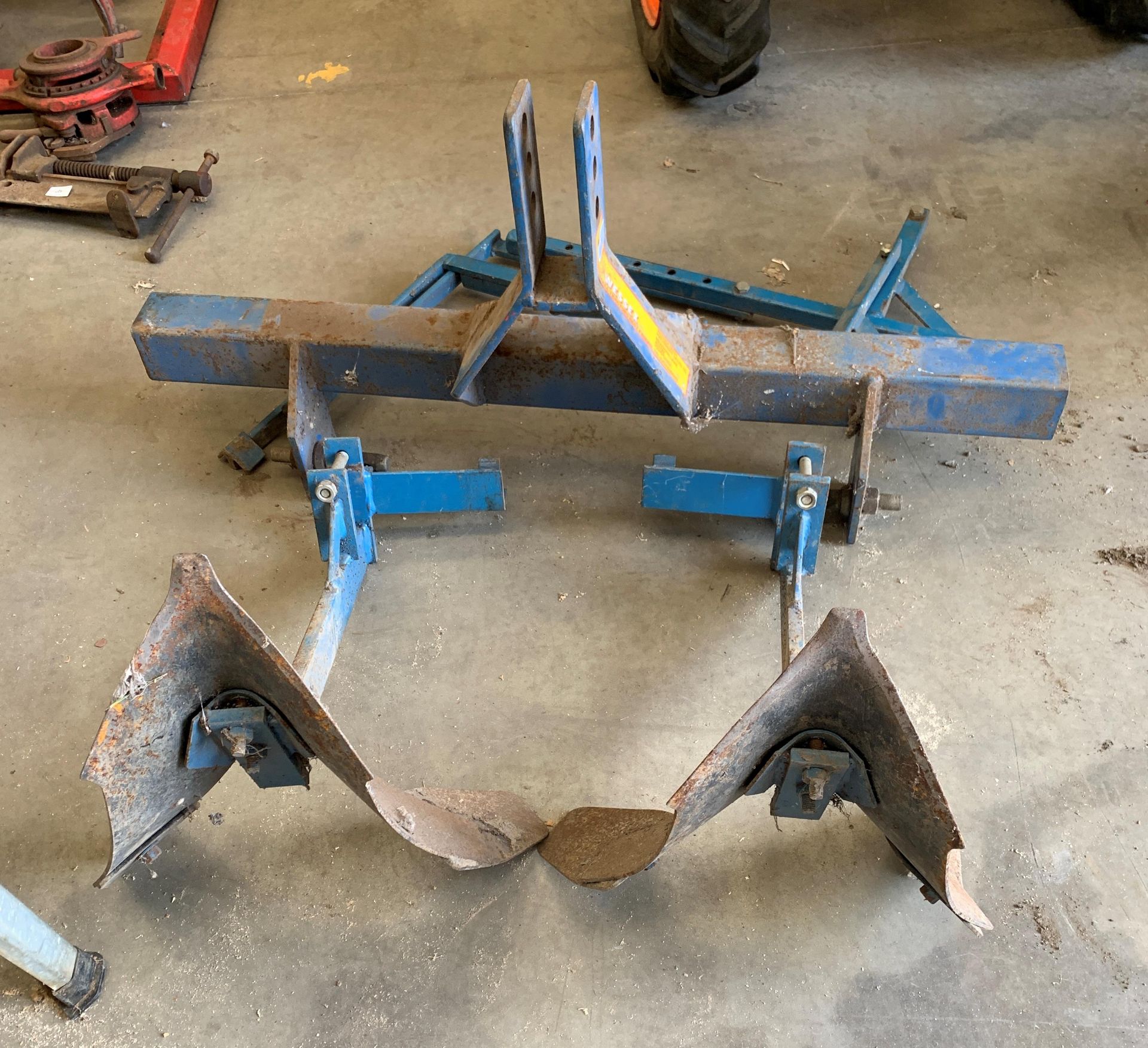 A blue metal frame TWO PLOUGH ATTACHMENT *Please note,
