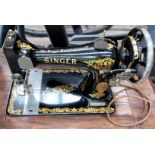 A Singer 240v electric sewing machine in an oak cabinet