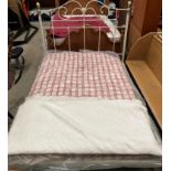 A white metal 4'6" double bed frame with 4' red and cream patterned mattress