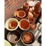 A large quantity of assorted terracotta and other plant pots, plant pot stands,