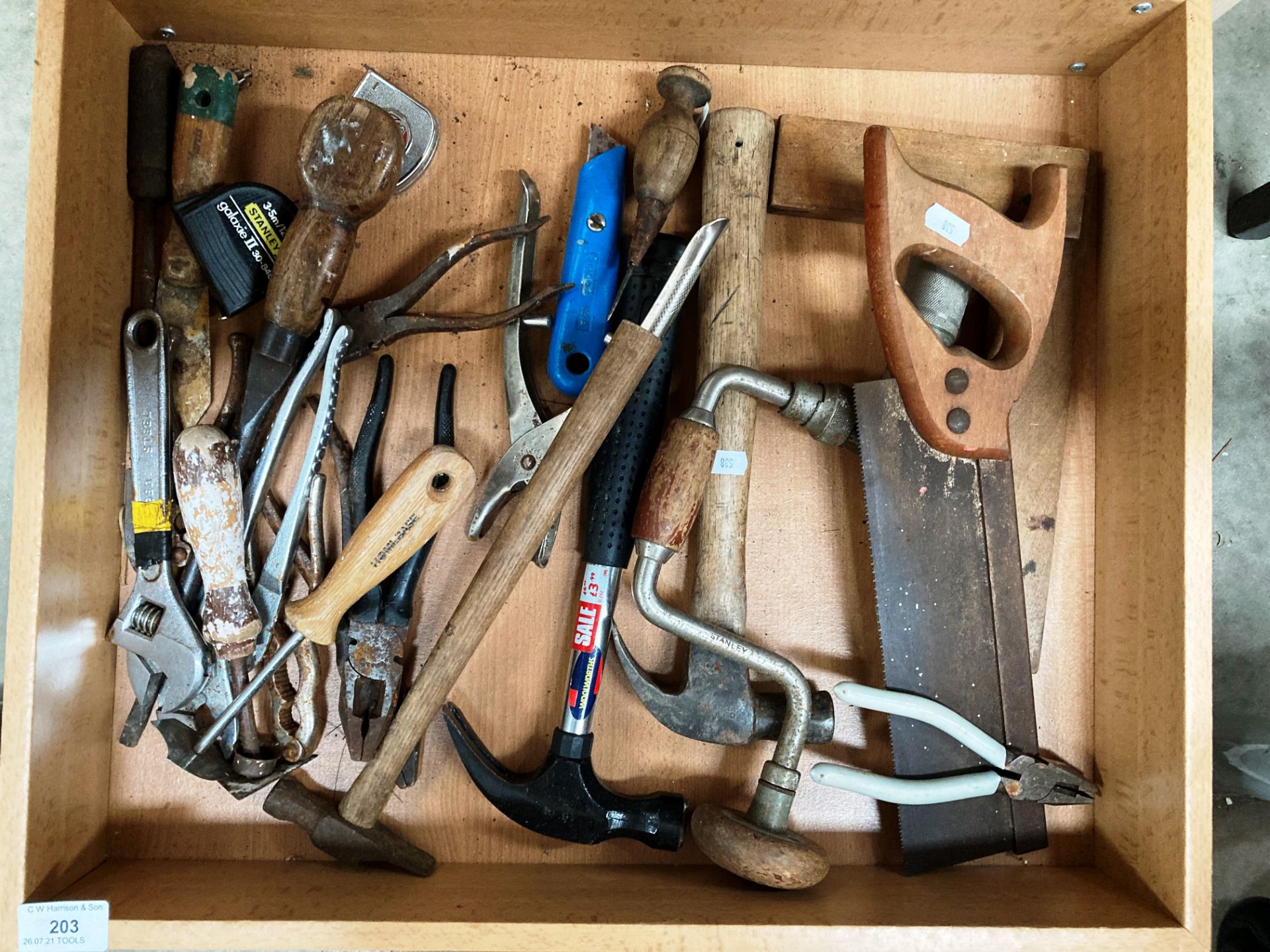 Contents to drawer - handsaw, hammers, pliers, adjustable wrench,