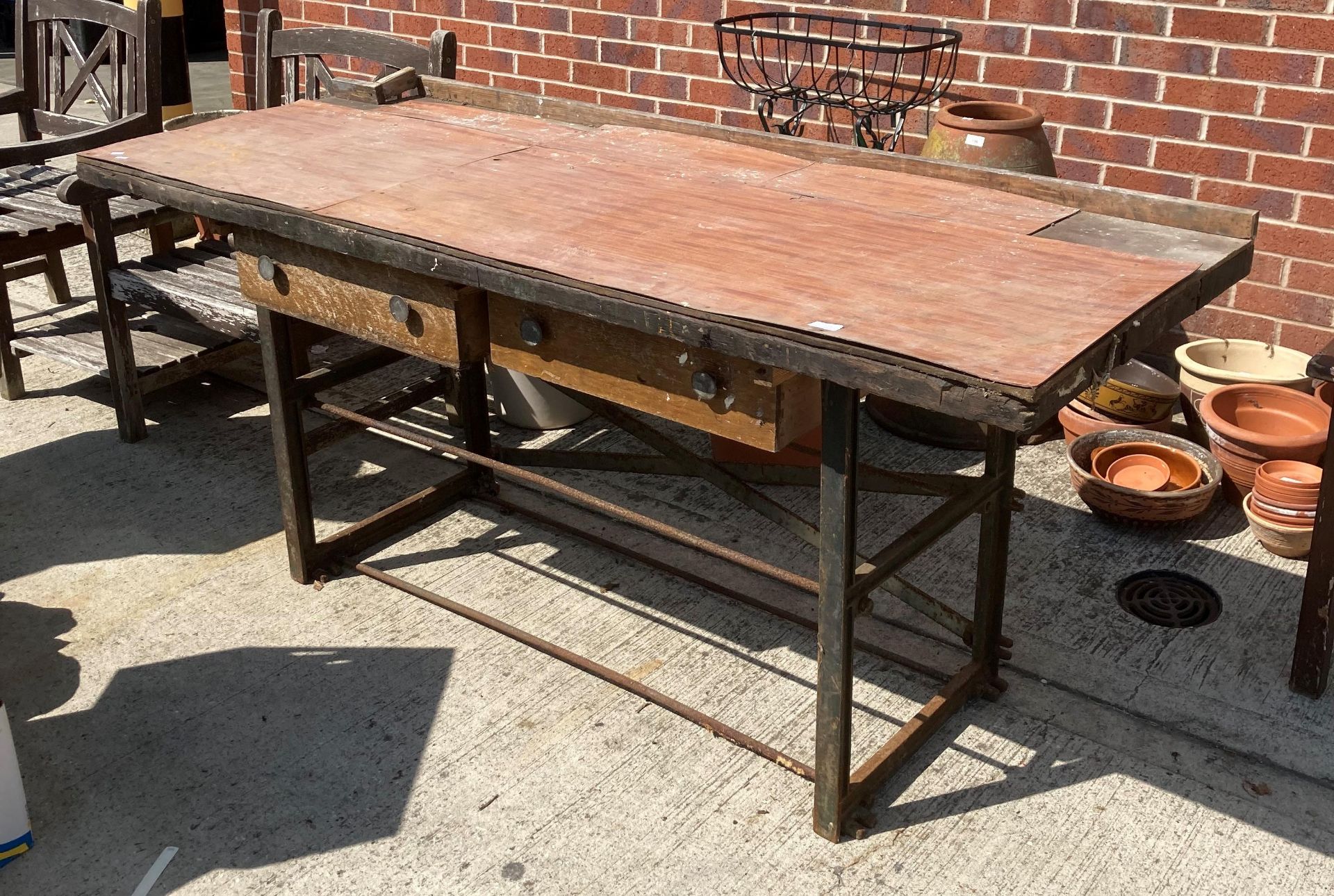 A metal framed, wood topped workbench,