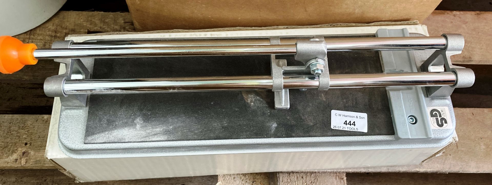 Manual tile cutter and contents to box garden hose and other accessories