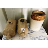 Two beige ceramic hot water bottles (one no stopper) and a jar (3)