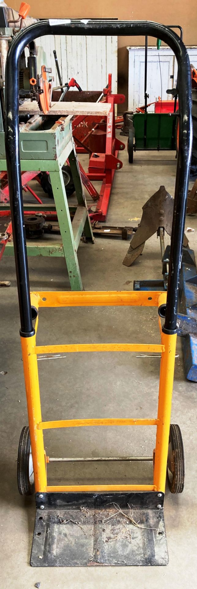 A yellow and black metal folding sack cart