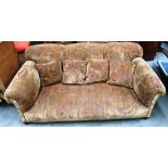 A medium brown floral upholstered three piece suite with brown vinyl sides and arms comprising a