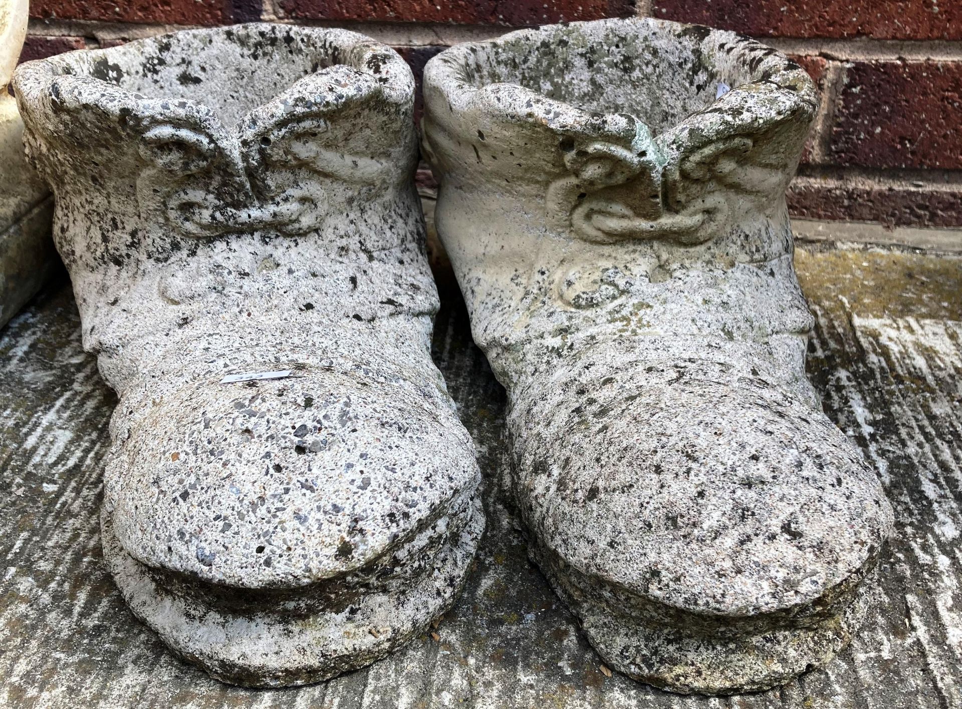 A pair of composition and concrete boot planters