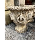 A pair of composition and concrete garden urns each 28cm high