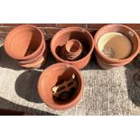 Eight large terracotta plant pots and a quantity of smaller terracotta plant pots