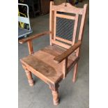 A modern Indonesian wood framed armchair