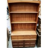 A Nathan teak wall unit with two shelves over four drawer two door base 103cm x 193cm high