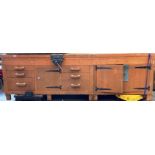 A substantial wood framed workbench with six drawers (do not open at present) and three drawers