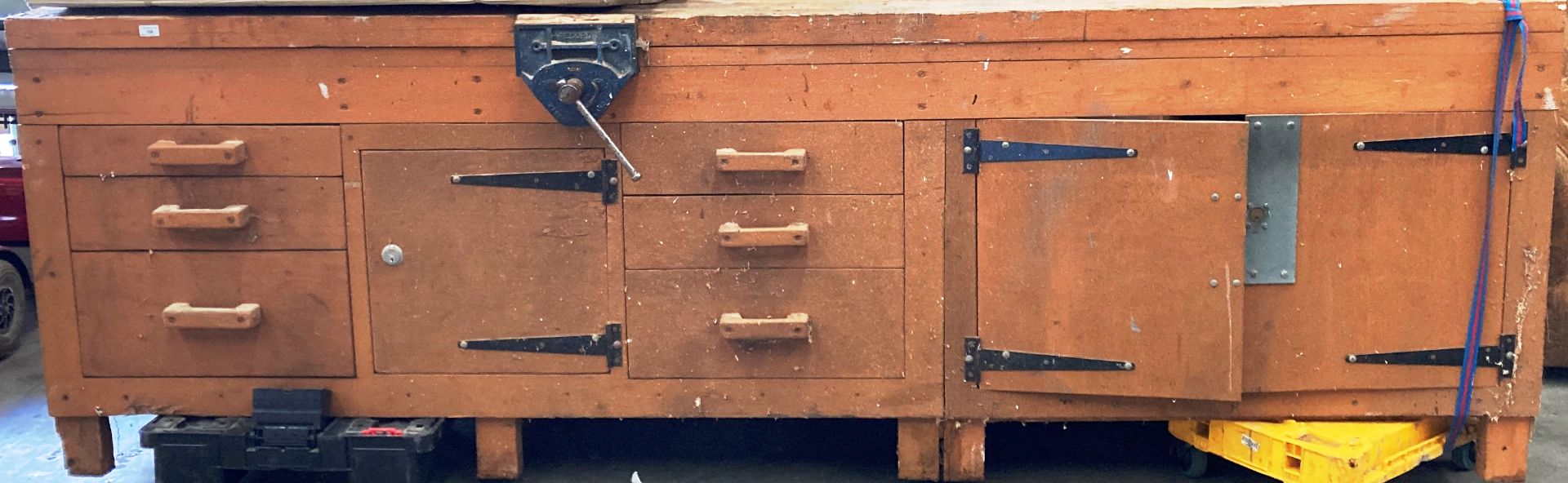 A substantial wood framed workbench with six drawers (do not open at present) and three drawers