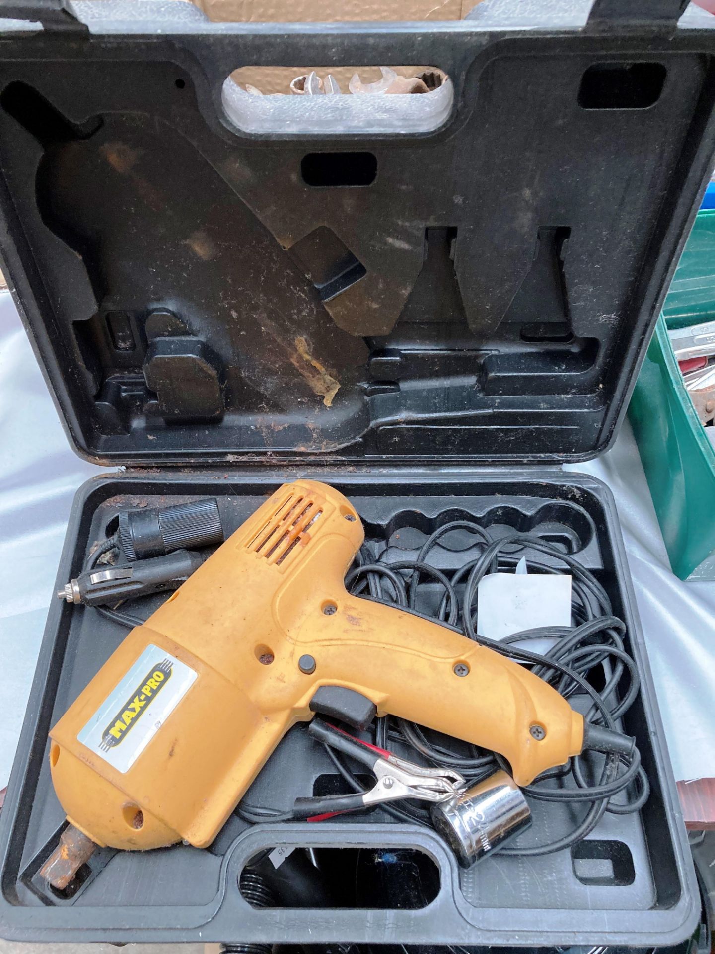 A Max Pro 12 volt impact wrench in black plastic case