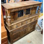 An oak sideboard dresser in the style of Old Charm with two leaded glazed doors over three drawer,