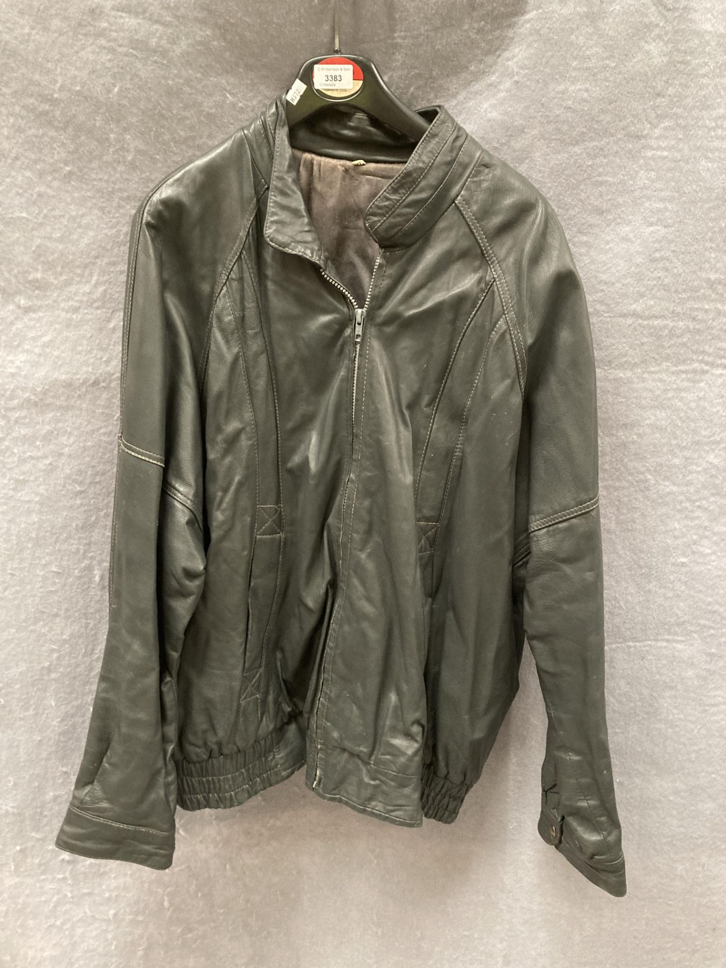 A dark grey vintage leather jacket,