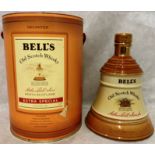 A porcelain decanter finished in 22 carat gold containing 75cl of Bell's Old Scotch Extra Special