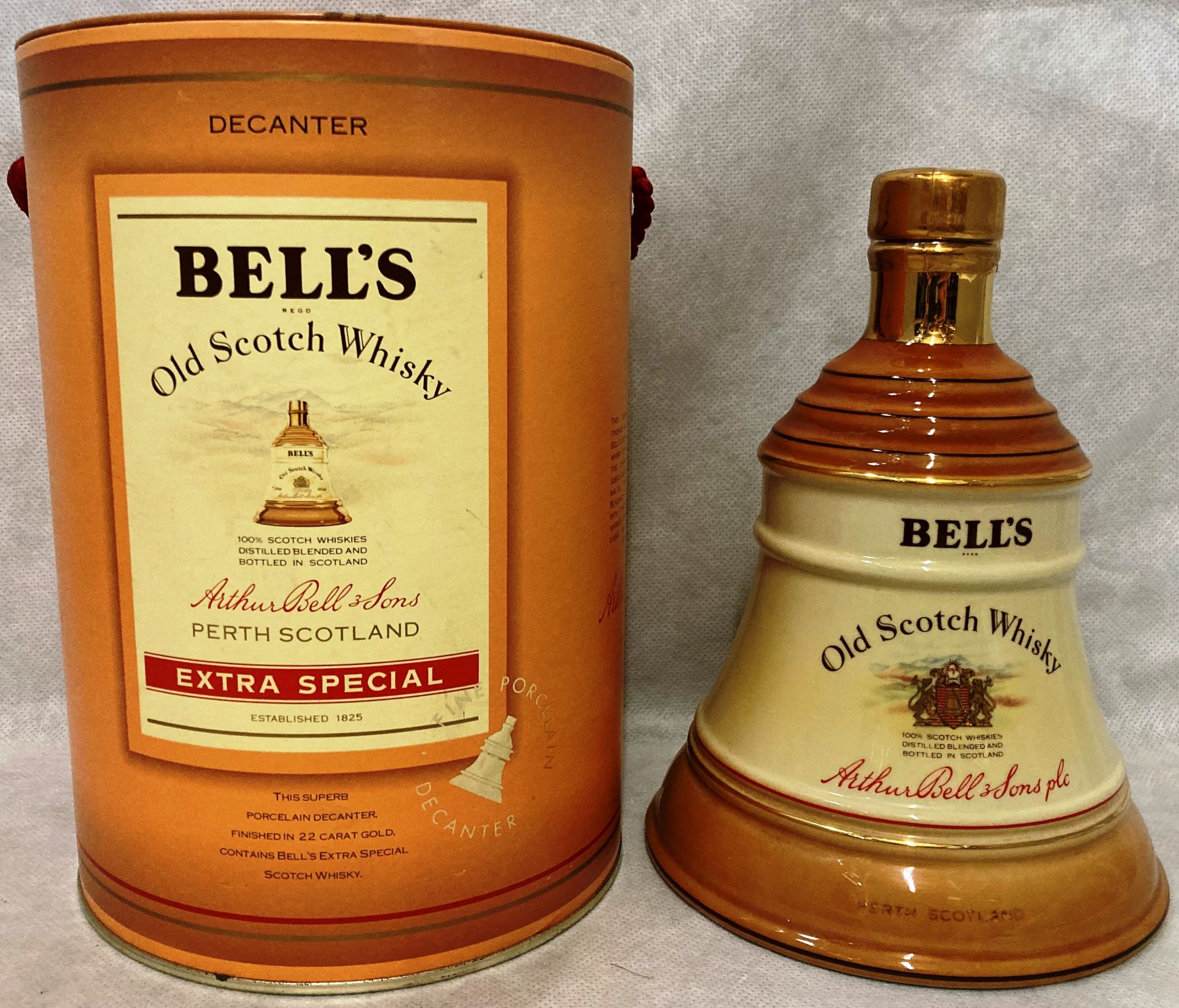 A porcelain decanter finished in 22 carat gold containing 75cl of Bell's Old Scotch Extra Special