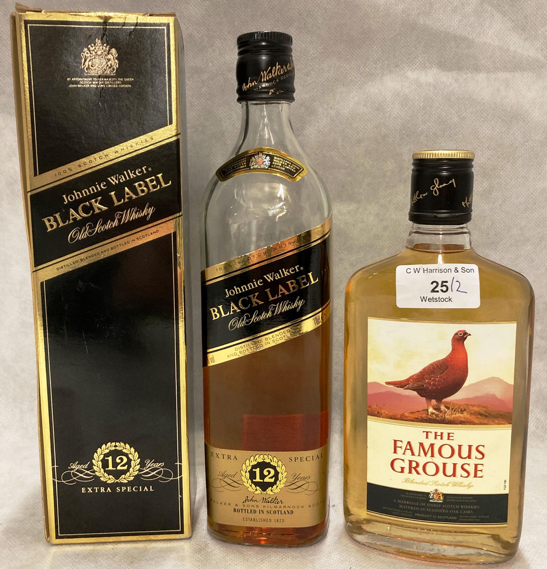 A 35cl bottle of The famous Grouse blended Scotch Whisky (40% vol) and a part bottle of Johnnie