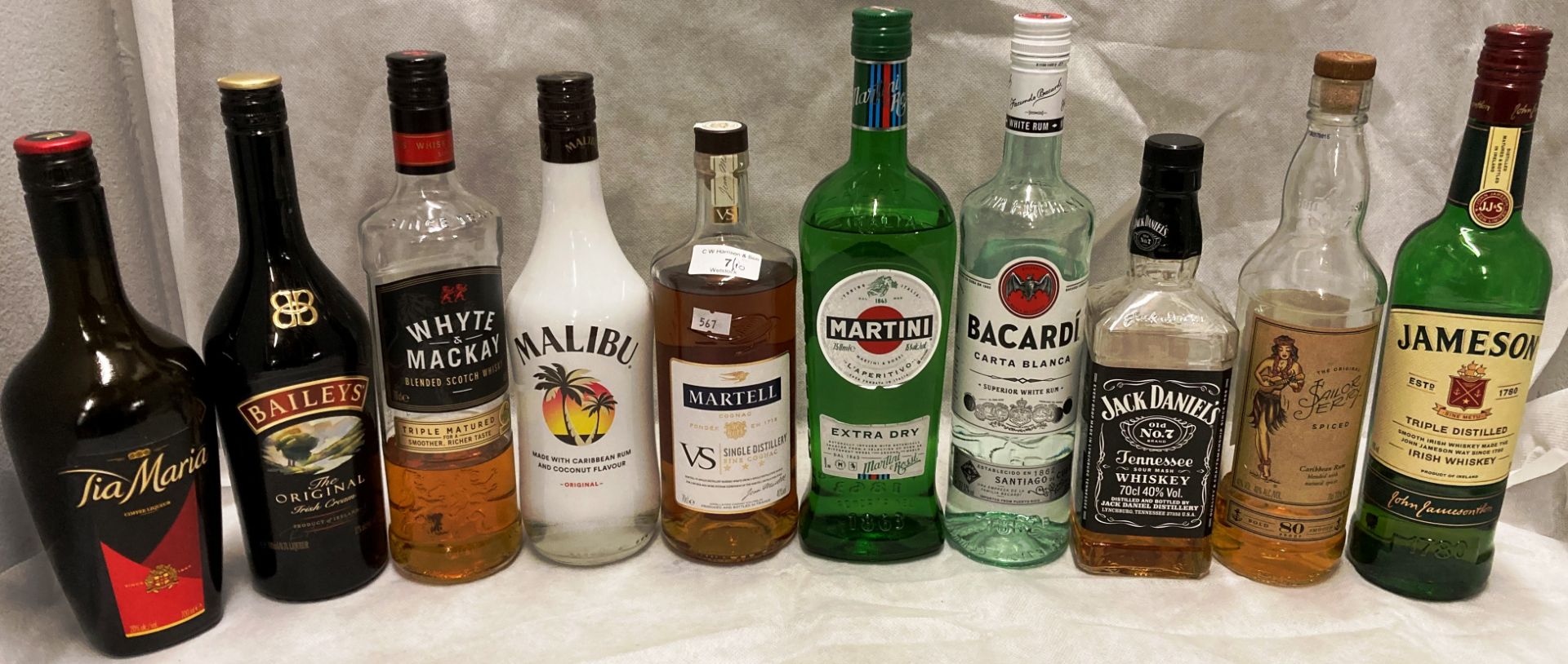 Ten various part bottles of spirits and liquors (range less than a quarter to three quarters full)