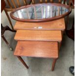 A set of three teak coffee tables and an oval framed wall mirror (2)