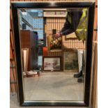 Large black and gold framed wall mirror,