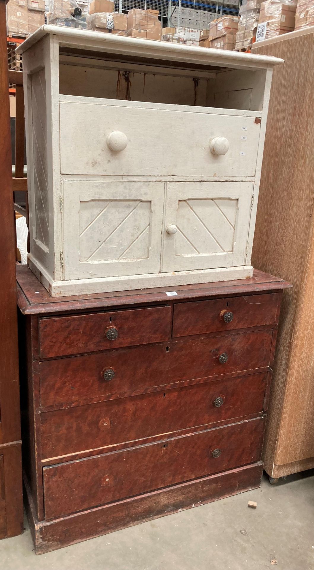 A stained pine five drawer chest of drawers (three long,