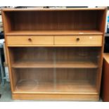 A Parker Knoll teak bookcase/side cabinet with open shelf over two drawers and glass sliding doors