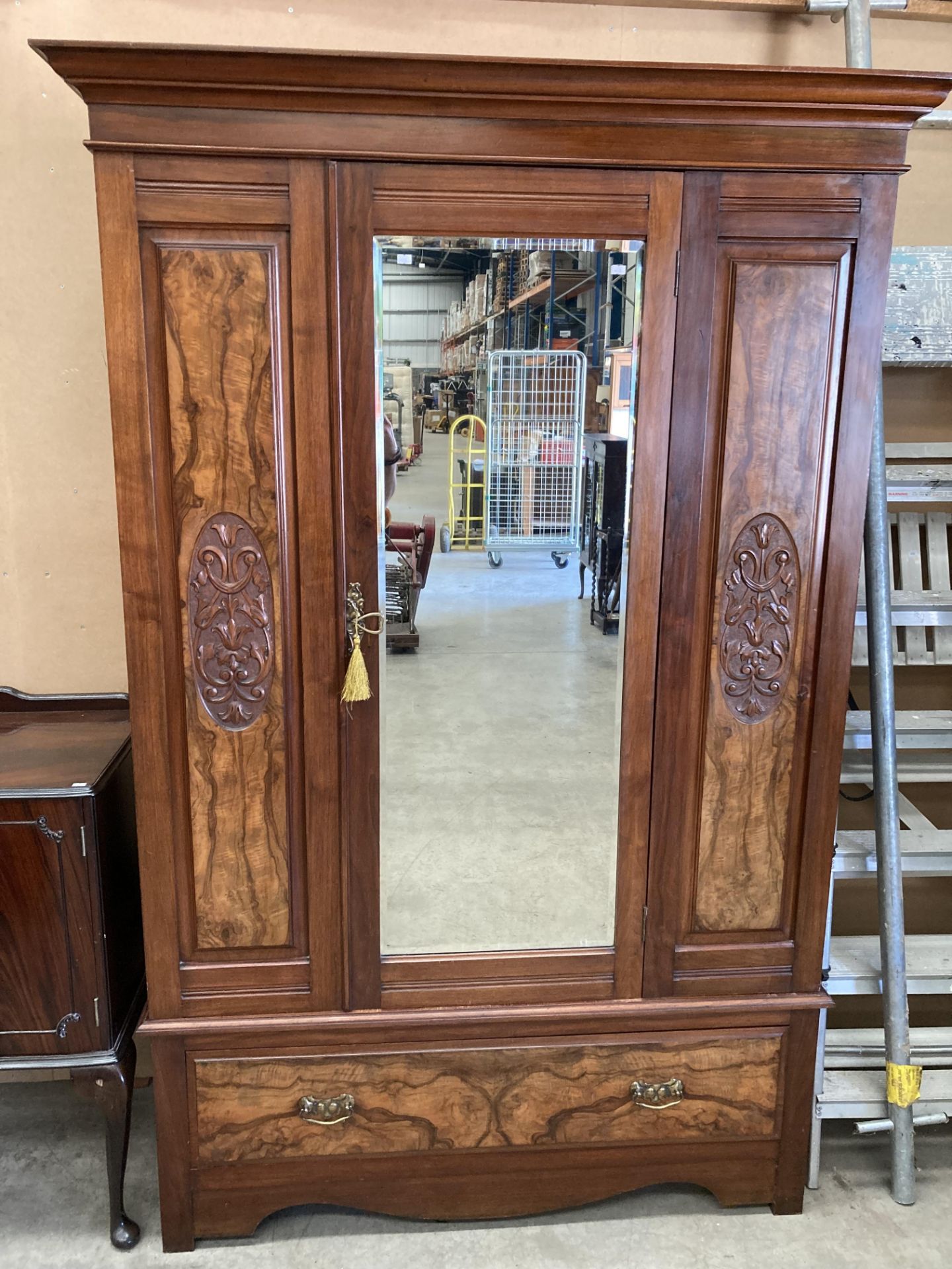A mahogany and walnut early 20th century wardrobe with centre mirror door over underdrawer 134 x