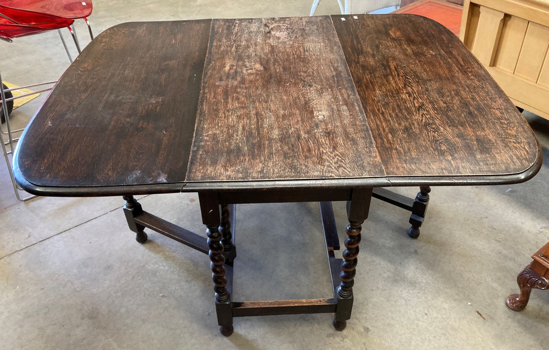 An oak drop leaf dining table with barley twist legs 100 x 135cm when open