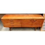 A teak three drawer two door sideboard 183cm long